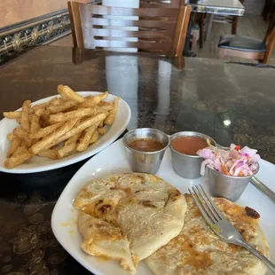 Pupusas, with chicken, cheese and jalapeños. Side of fries and a 2oz side of very spicy salsa.