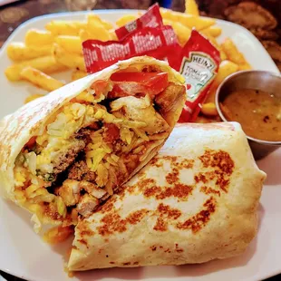 Deluxe burrito with fries and salsa ranchero. Toppings that come with the burrito are rice beans sour cream and sautéed veggies