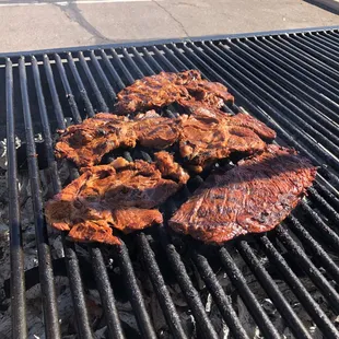 Carne Asada steaks cooking on the grill.