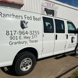 a van parked in front of a building
