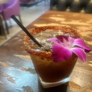 a drink with a flower garnished in it