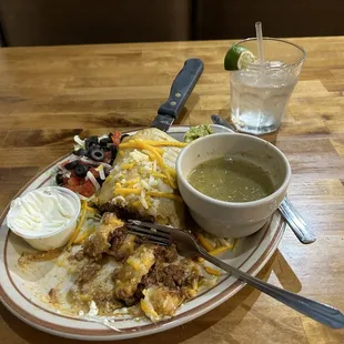 A beef chimichanga with green sauce on the side, sour cream and guacamole. !