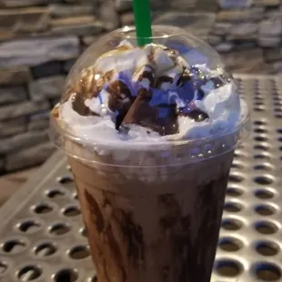 a chocolate milkshake with whipped cream and chocolate sprinkles