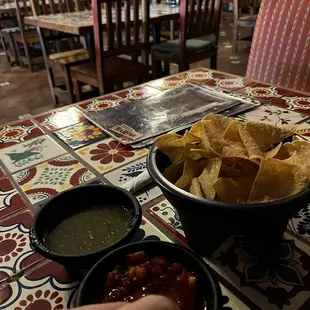 a bowl of chips and a bowl of salsa