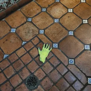 Men's bathroom, used glove on floor.