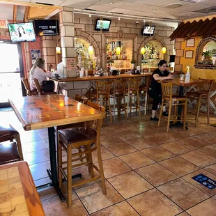 people sitting at tables in a restaurant