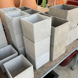 Square cements pots in several sizes.