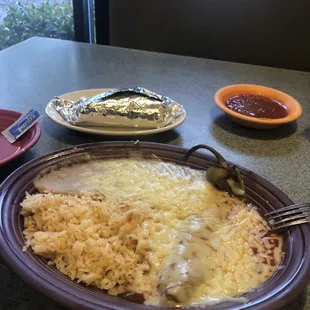 Chile relleno with rice &amp; beans. Taco and salsa towards the back.