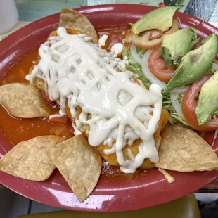 Shredded chicken burrito; included layers of chicken, Mexican rice, and refried beans inside a tortilla.