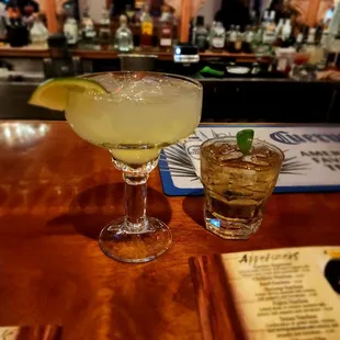 two cocktails on a bar