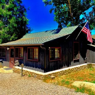 The smaller log cabin used to be a school house