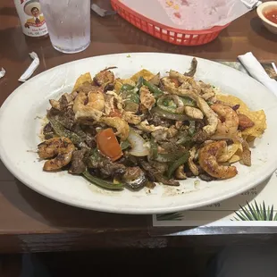 Monster Nachos (Steak, chicken, shrimp, cheese, bell peppers, onions)