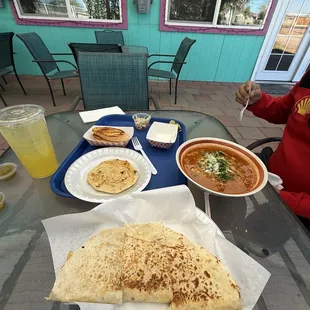 Sitting on the patio, enjoying Pupusas de Chicharron con Queso, Menudo Rojo a Quesadilla de Asada,
