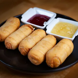 a plate of food with dipping sauces