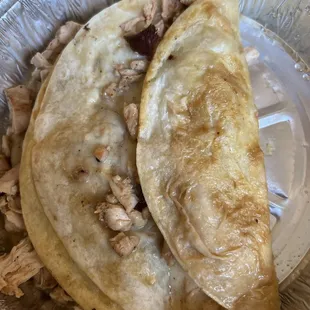 Supposed to be a quesadilla but is a soggy tortilla and cheese with dry chicken taco.