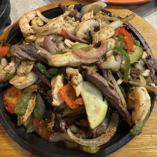 Lunch special FAJITAS TEXANAS $14.95 Steak, chicken and shrimp. Served with rice, beans and mexican salad. Corn or flour tortillas
