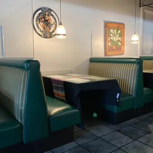 a booth with green booths