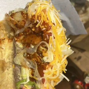 a hand holding a taco