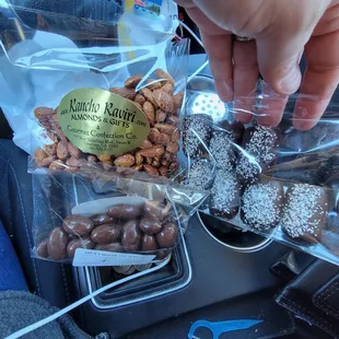 a person grabbing a bag of nuts