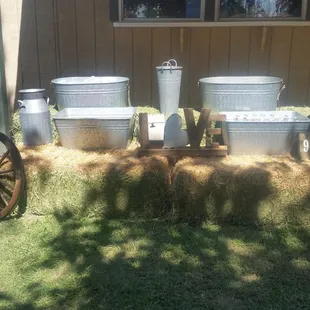 Hay bales used in a display. The tins held iced drinks.
