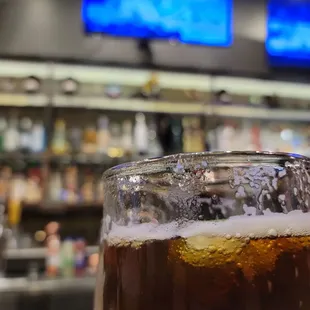 a glass of beer in front of a bar