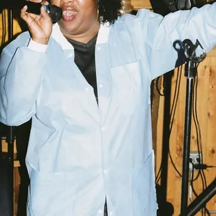 a woman singing into a microphone