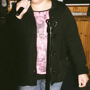 a woman singing into a microphone