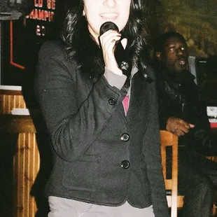 a woman singing into a microphone