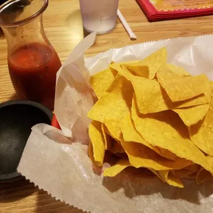 a basket of chips and a bottle of ketchup