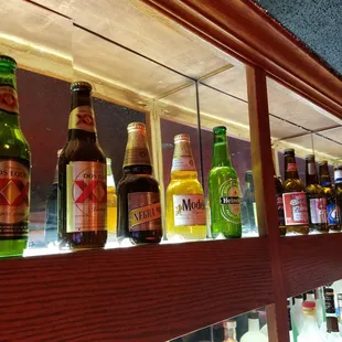 a row of beer bottles on a shelf