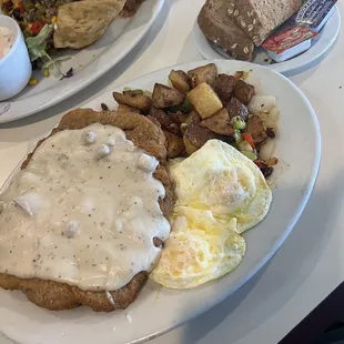 Country fried steak, country potatoes, eggs, wheat toast.
