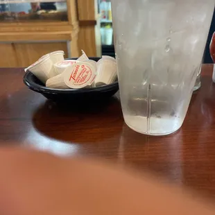 a glass of water and a plate of ice cubes