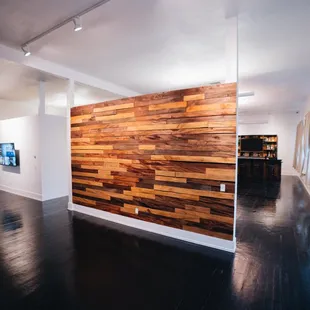 A wood decorative wall, perfect for pictures! There is also a tv placed near the entryway for a slideshow or anything else.