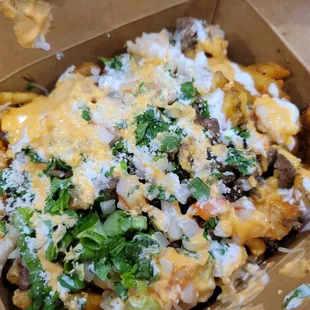 So much yummy fries packed inside this box including carne asada and shrimp!