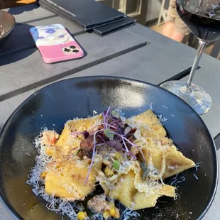 a plate of pasta and a glass of wine