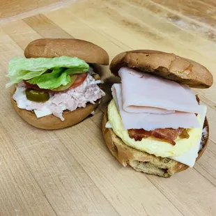 two sandwiches on a wooden table