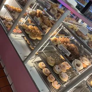 a variety of donuts in a display case