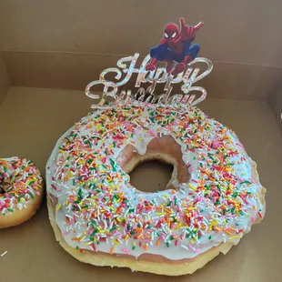 a happy birthday donut with sprinkles
