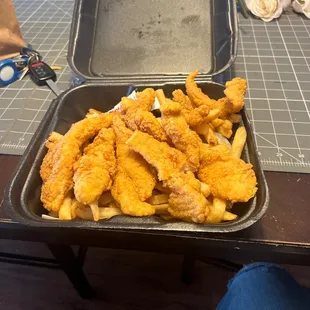 a tray of fried fish and fries