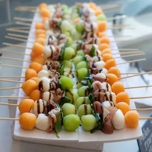 Exquisite skewers featured at a recent event, beautifully catered with fresh fruits, meat, and cheese.