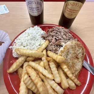 Grilled chicken and pulled pork combo plate with fries and Cole slaw.