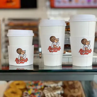 three cups of coffee and a box of donuts