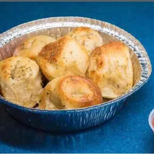 Fresh hot delicious garlic knots with homemade marinara dip