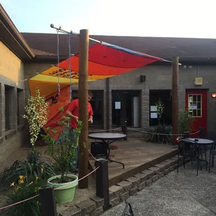 a patio with tables and umbrellas