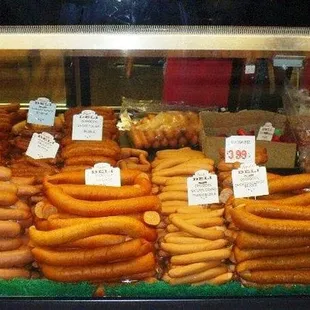 a variety of sausages in a display case