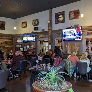 a large group of people sitting at tables in a restaurant