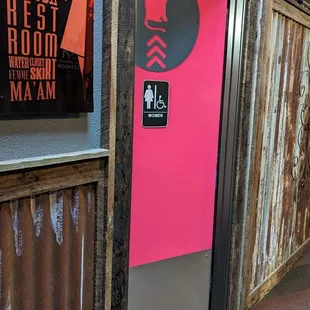 a woman's face on a pink door