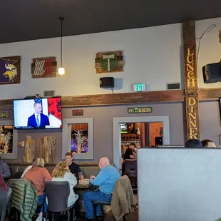 people sitting at tables in a restaurant