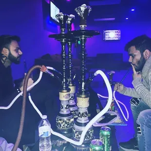 two men smoking a hookah