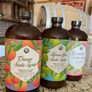 three bottles of orange soda